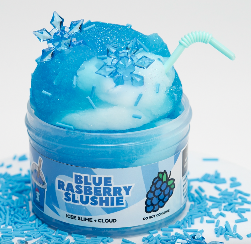 Blue raspberry slushie slime in a container with a straw and snowflake decorations on a white background.