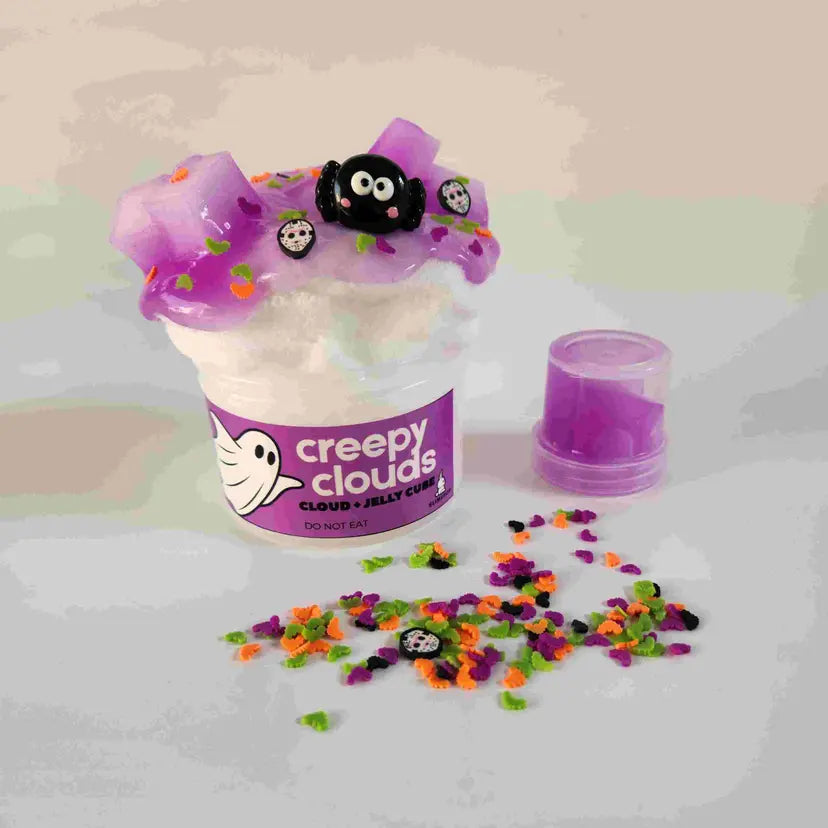 Halloween-themed slime with 'creepy clouds' label and colorful sprinkles on a light background