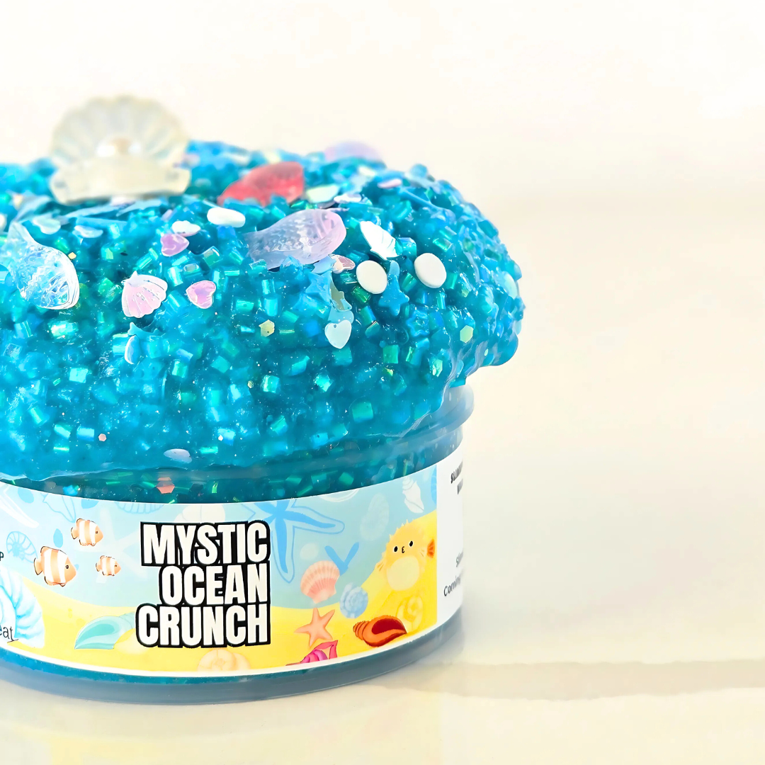 A jar of Mystic Ocean Crunch Slime with vibrant blue color and sparkling textures, adorned with ocean-themed decorations on the label.