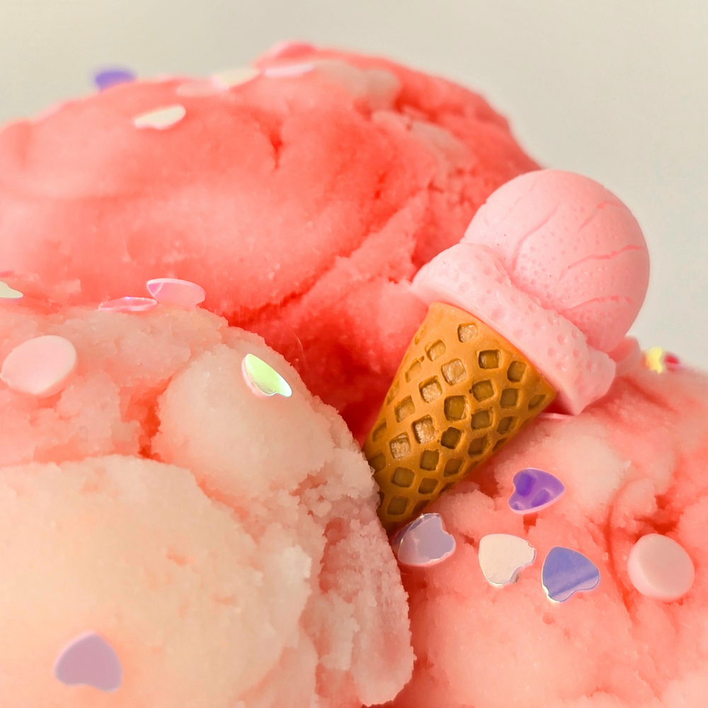 close up of peacie clouds slime showing an ice cream charm with glitter heart shaped chunky glitter