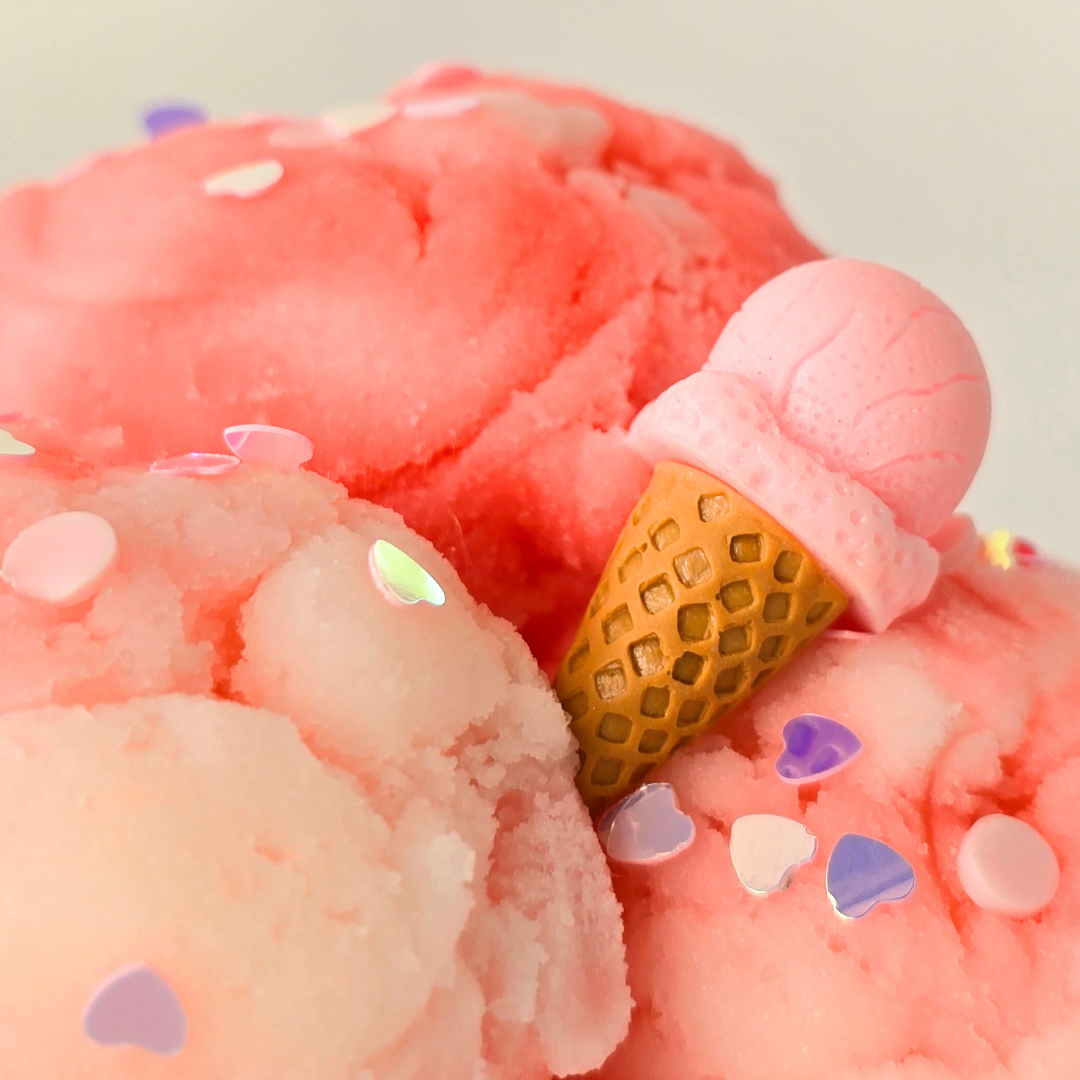 close up of peacie clouds slime showing an ice cream charm with glitter heart shaped chunky glitter