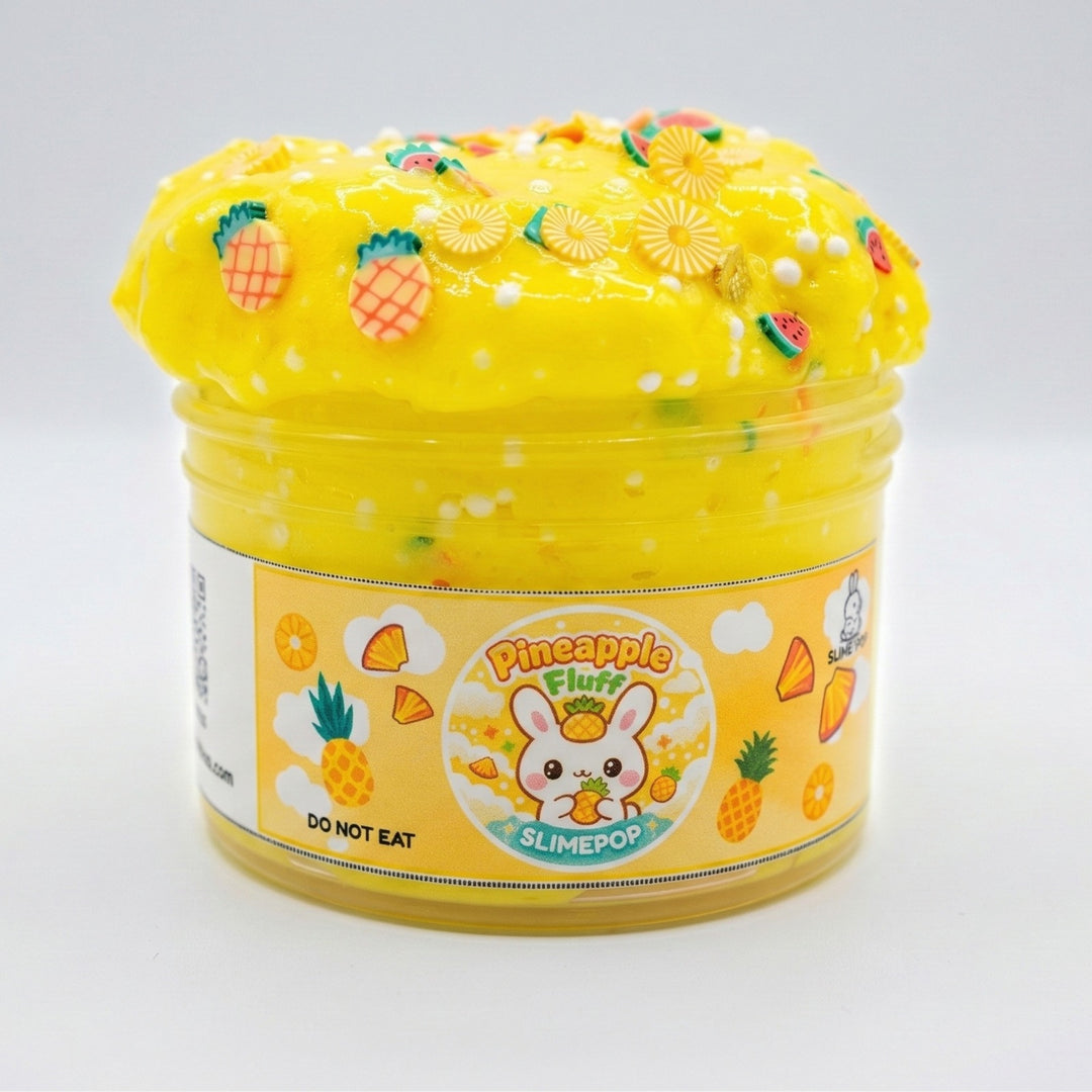 Slimepop Pineapple Fluff floam slime in a jar, featuring a bright yellow crunchy texture with foam beads, topped with pineapple polymer clay slices and a kawaii bunny label.