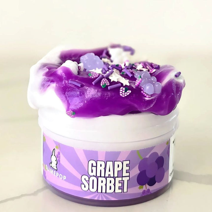 Close-up of the translucent purple jelly texture of Grape Sorbet slime showing gummy bear charms