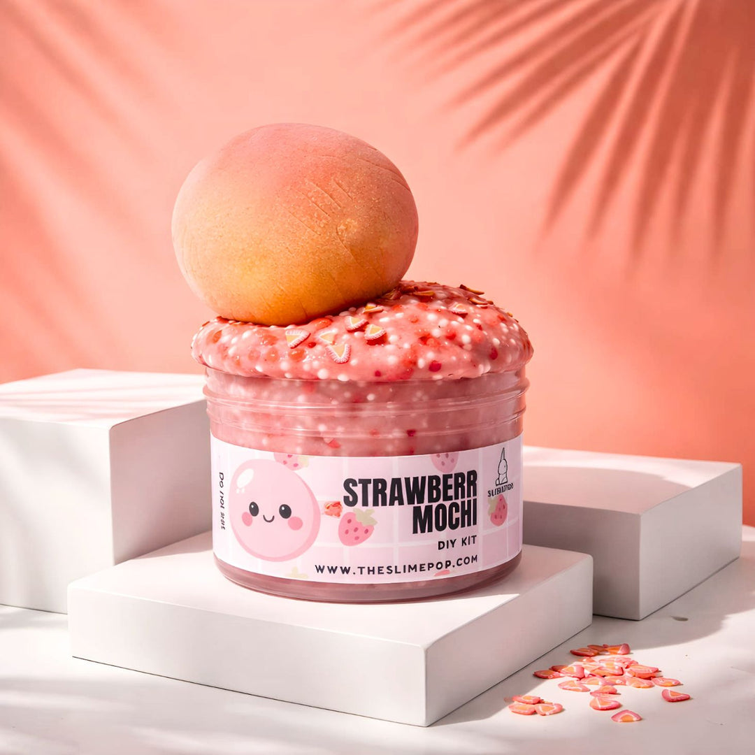A 7oz container of pink jelly slime base topped with a handcrafted clay strawberry mochi, strawberry sprinkle mix