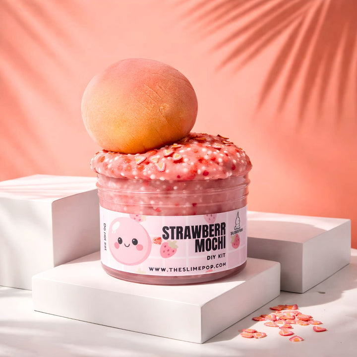 A 7oz container of pink jelly slime base topped with a handcrafted clay strawberry mochi, strawberry sprinkle mix